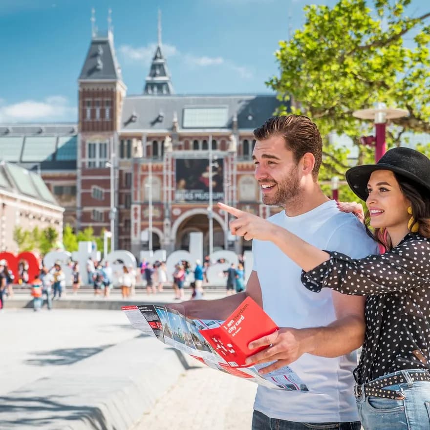A couple at the Museumplein holding a city card map