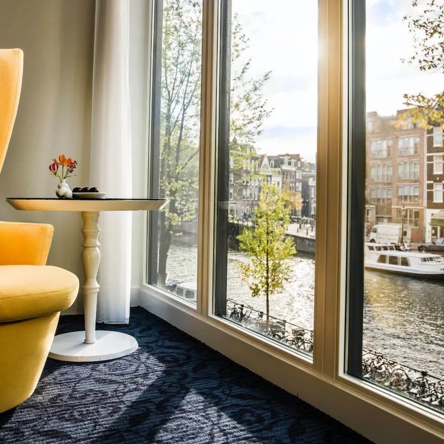 Chair at the window in hotel Andaz with view on the Prinsengracht.