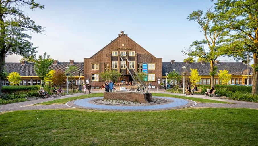 't Zonnehuis exterior and green square in front by day