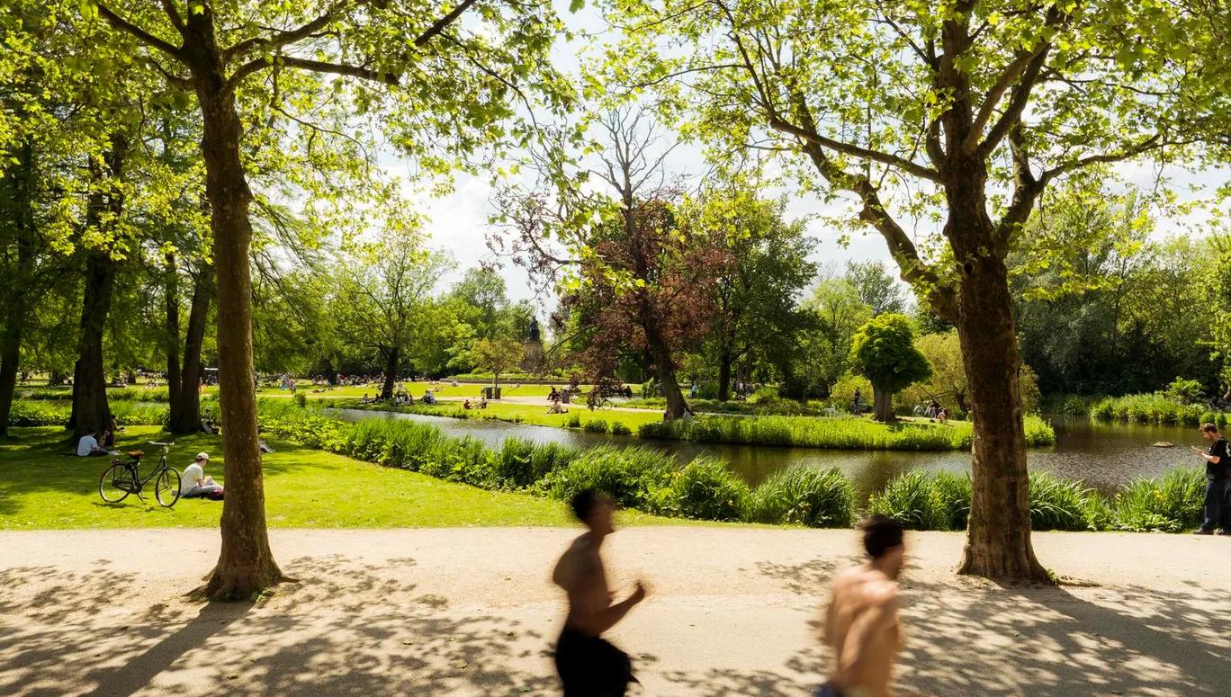 Joggers running through Vondelpark.