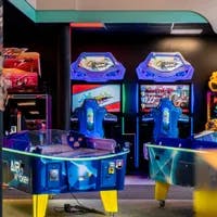 Arcade with anime interior, design and toys and gifts. Arcade machines and air hockey, racing games, colorful