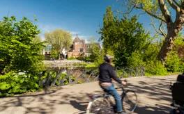 A person cycles through Oosterpark.