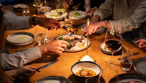 Diners tucking into dishes at ARCA Portugese restaurant at the art'otel