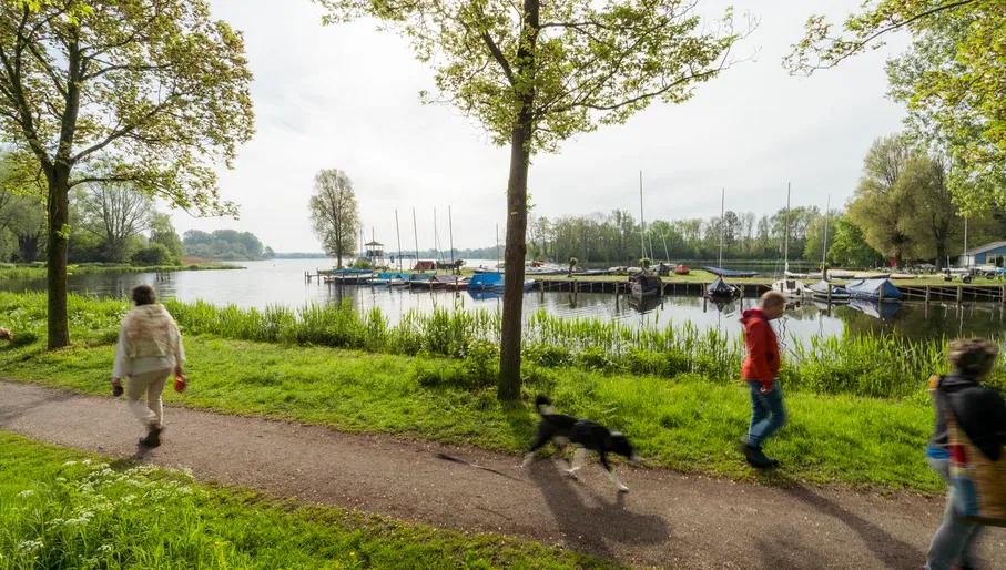 People take a walk alongside Gaasperplas.