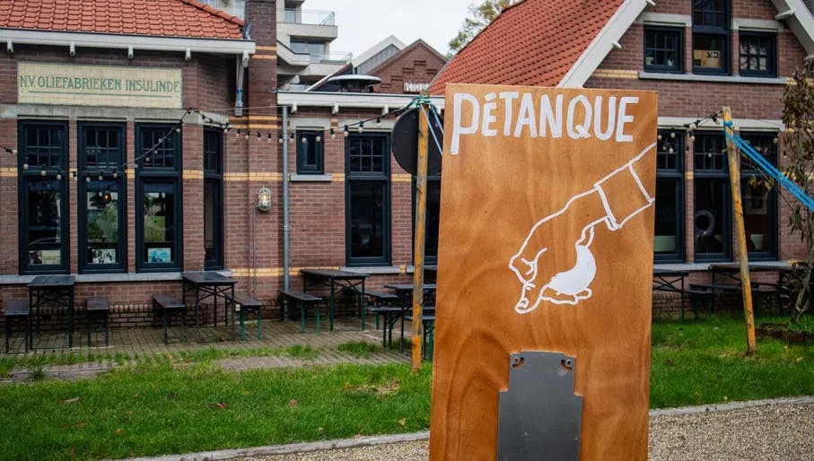 Oostelijk Havengebied, petanque jeu de boules spot with sign outside at Krux bouwwerf.