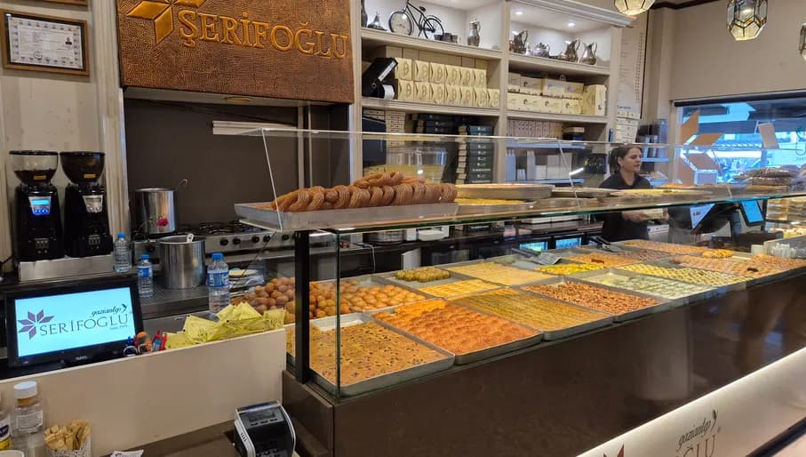 Interior of Şerifoğlu Café & Patisserie with baklava and sweet pastries on display