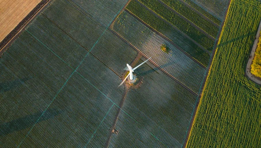 Zero emission. Top down aerial view on a Wind turbine eco farm on farm fields landscape