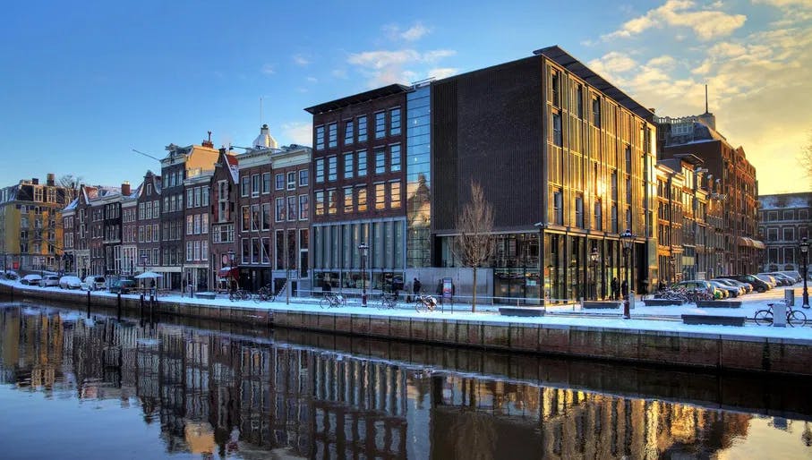 Exterior of Anne Frank House museum on Prinsengracht surrounded by snow.