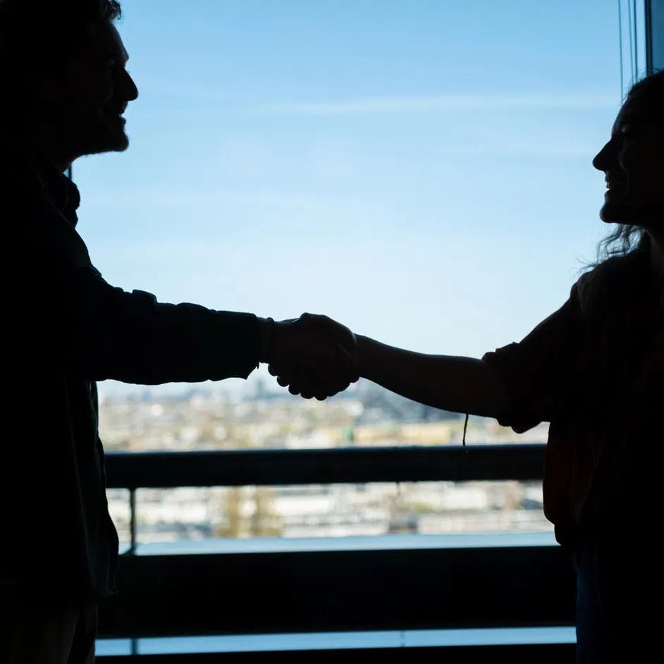 Man and woman handshake.