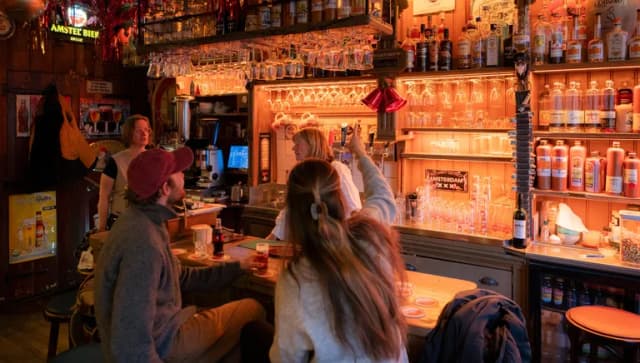 People sitting in brown bar Proeflokaal De Ooievaar