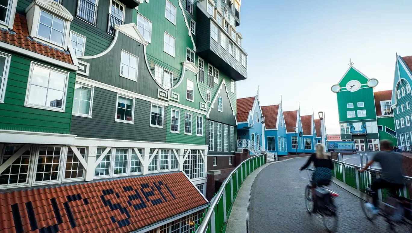 People cycling next to the iconic Zaan hotel in Zaandam