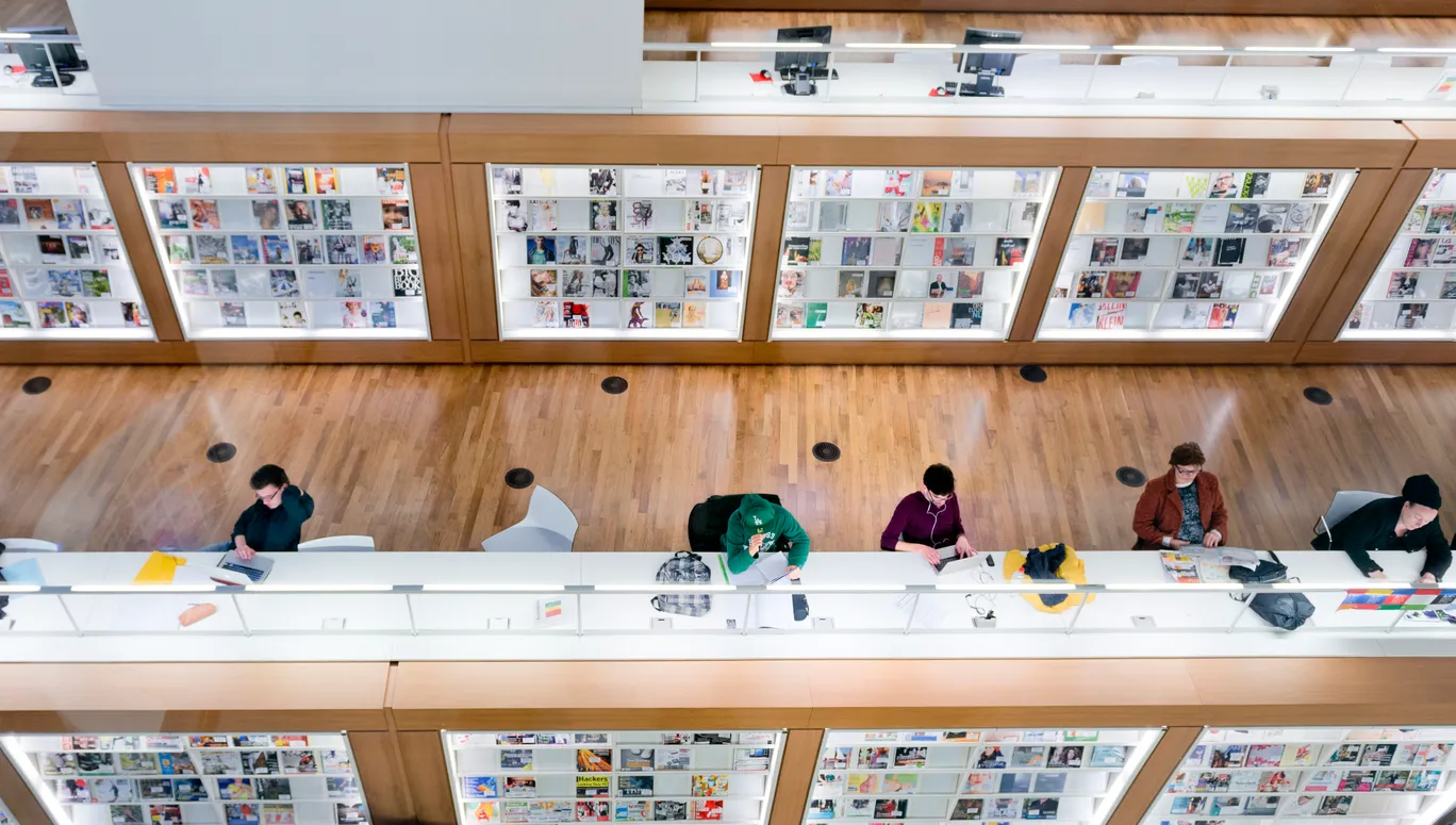 Amsterdam, the Netherlands - March 12, 2014: people, student are reading or working on the computers inside the modern central Public Library of Amsterdam, selected as best library of the Netherlands in 2012.