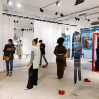 People looking at clothes at the new normal gallery