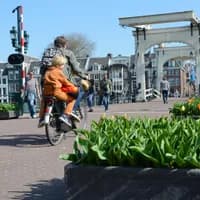 People walking and cycling over the Magere Bridge