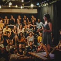 Speaker storytelling on stage at Mezrab