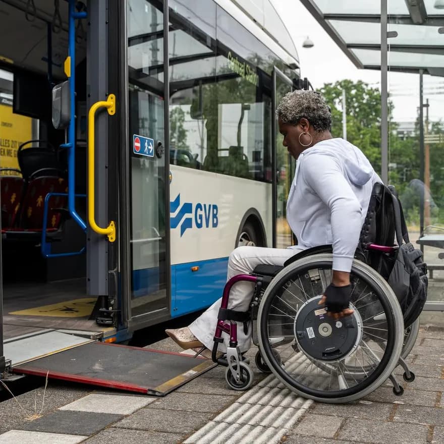 A person in a wheelchair enters the bus.