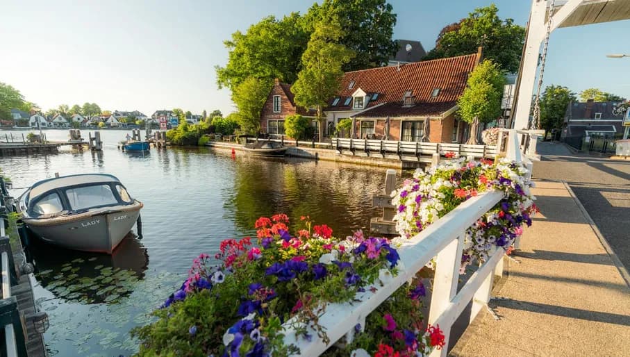 A boat in the water near the church bridge (Kerkbrug) over the river Amstel in the village of Oudekerk aan de Amstel.