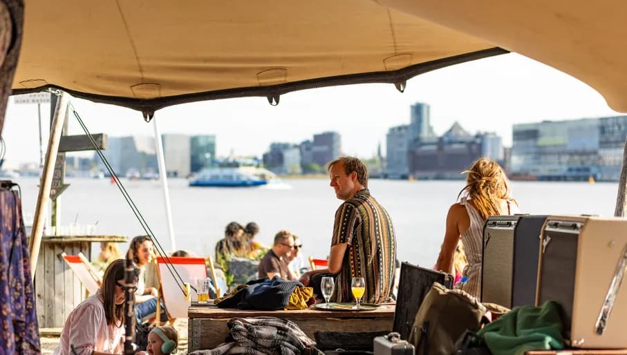 People chilling on the city beach of Pllek